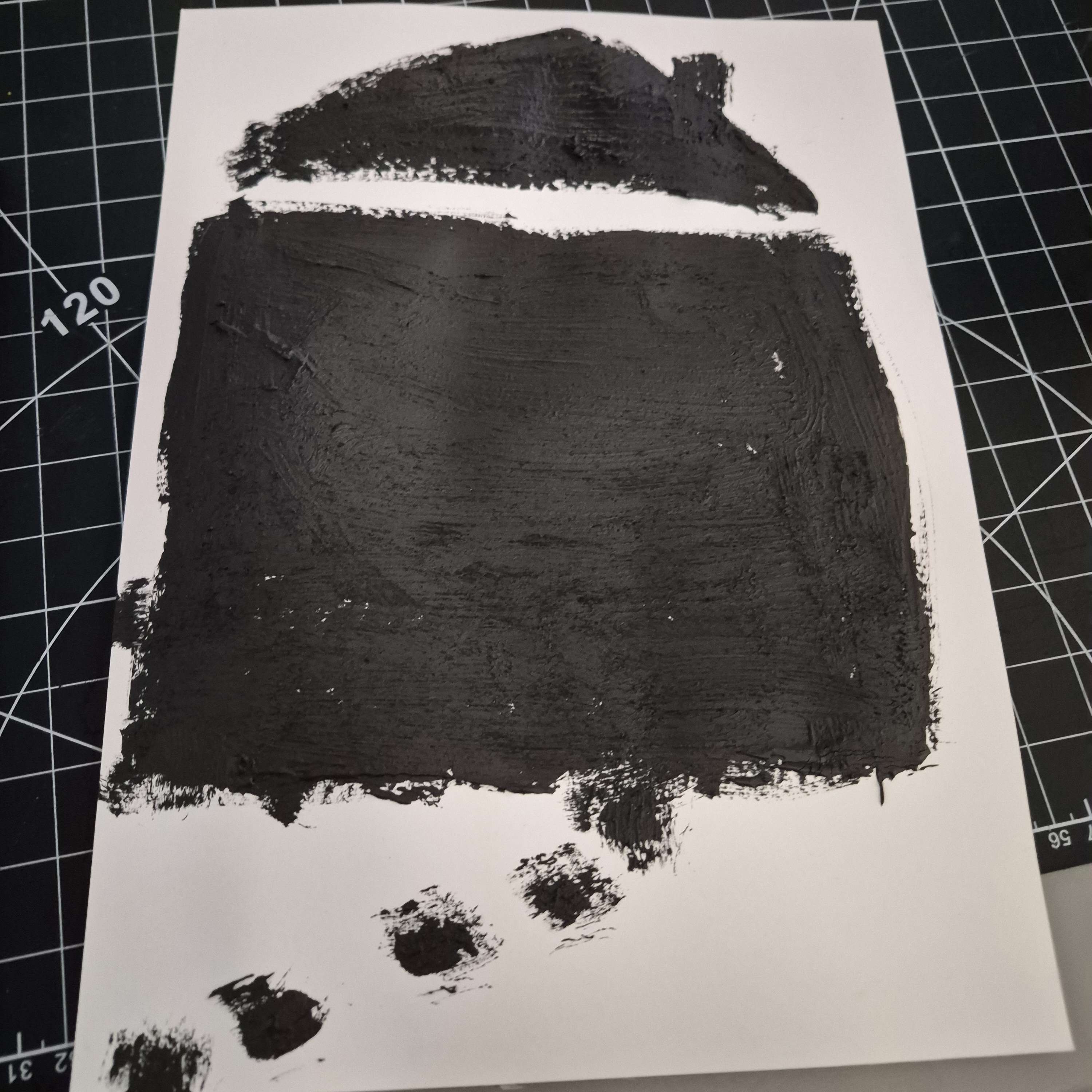 Graphite paint is used to create a conductive house drawing that acts as a touch-based input surface for interaction.